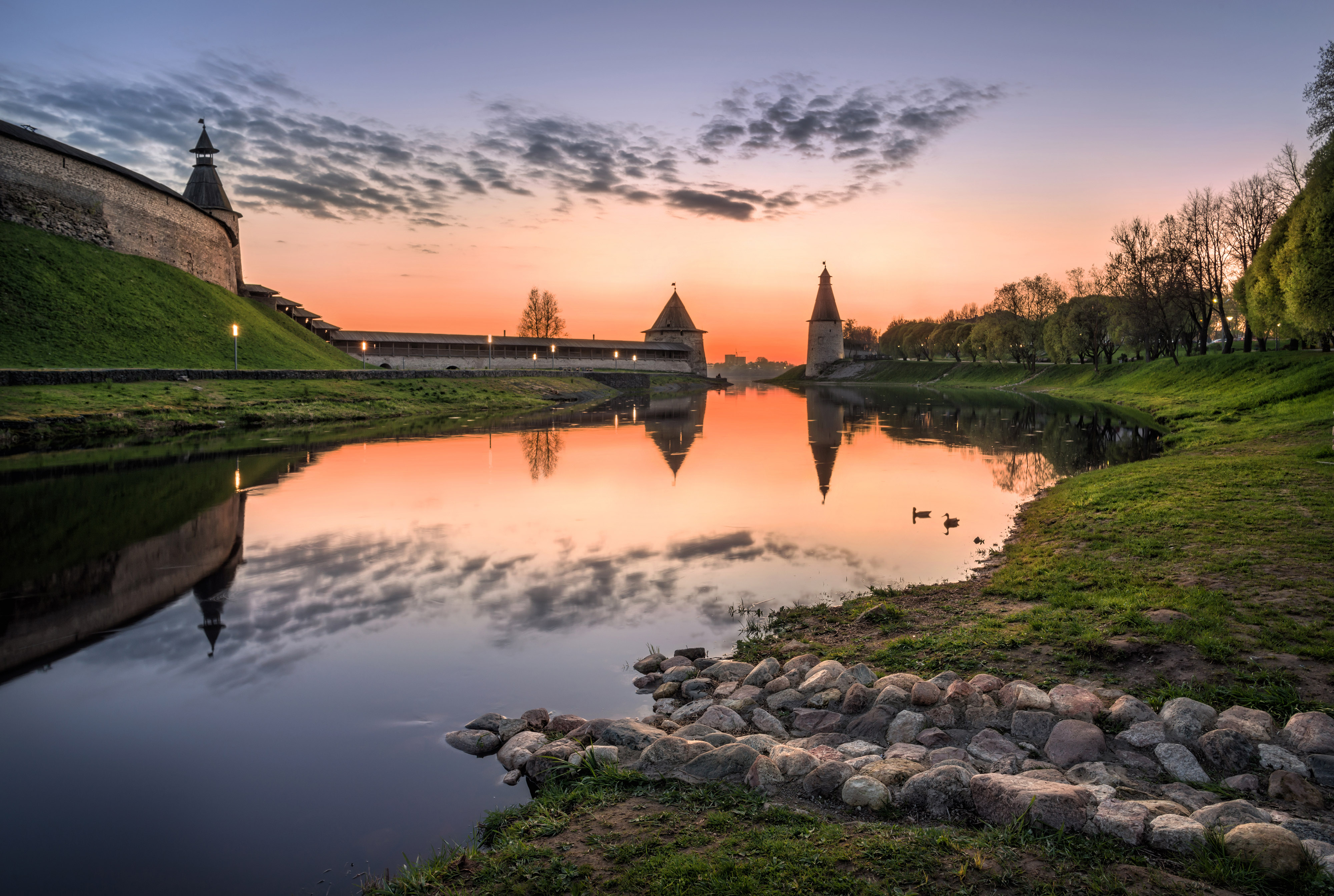 Clouds like wings, in red sunset sky over Pskov Kremlin